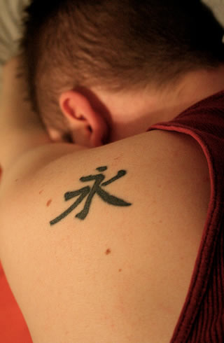 tattoos on Americans with Chinese symbols for words like love, peace,